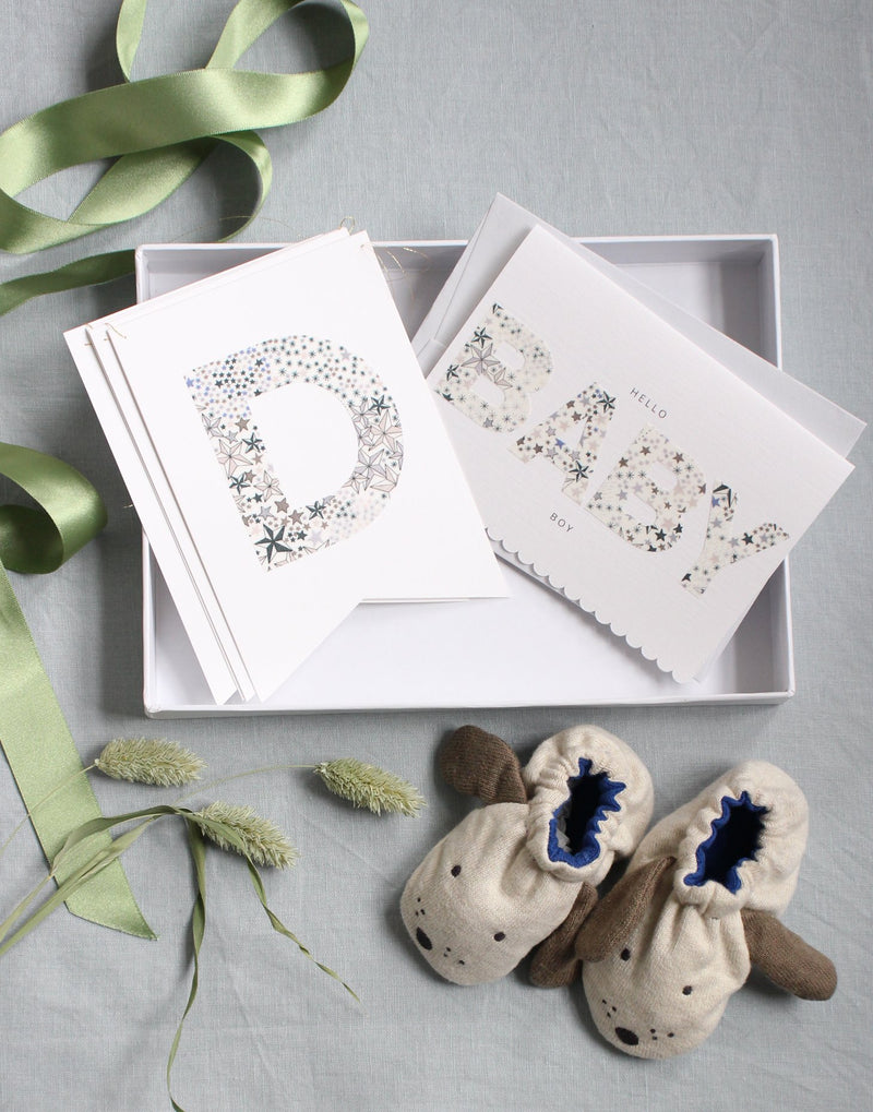 New baby boy gift box including Liberty print bunting, baby booties and new baby card from The Charming Press.