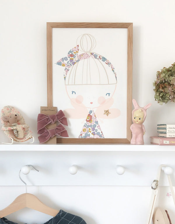 Children's bedroom with wall art by The Charming Press featuring a fairy with glitter wand. 