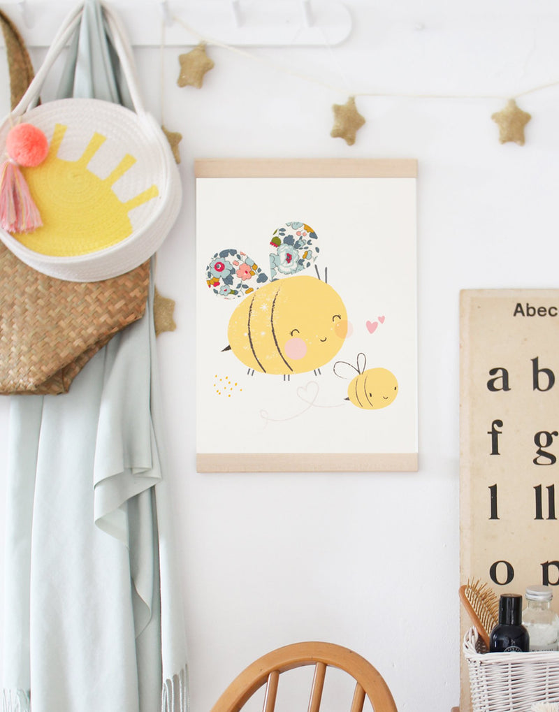 Liberty print Bumblee Bee nursery art by The Charming Press shown hanging on a shelf in children's bedroom