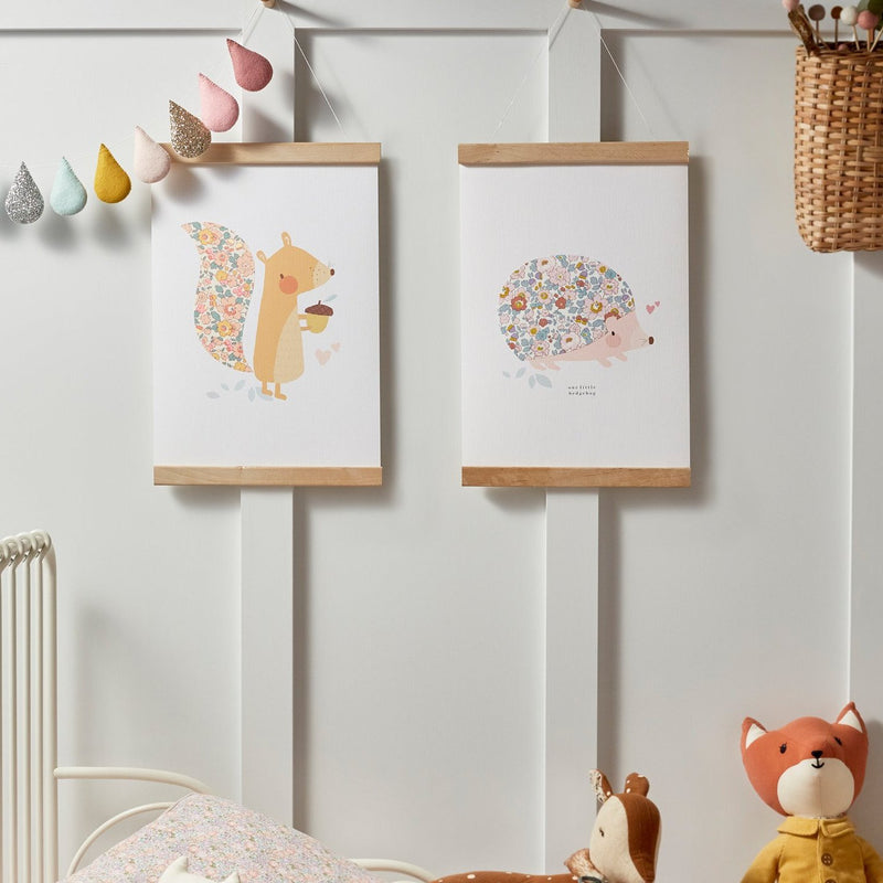 Children's bedroom with gallery wall, featuring squirrel and hedgehog wall art from The Charming Press.