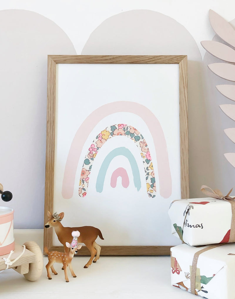 Pastel rainbow wall art with Liberty print fabrics by The Charming Press shown in a nursery.