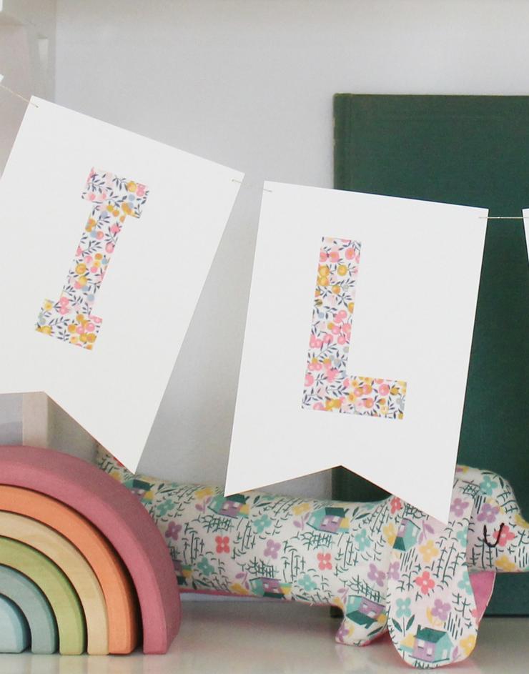 Close of up Liberty fabric Wiltshire Bud letters of the bunting decor.