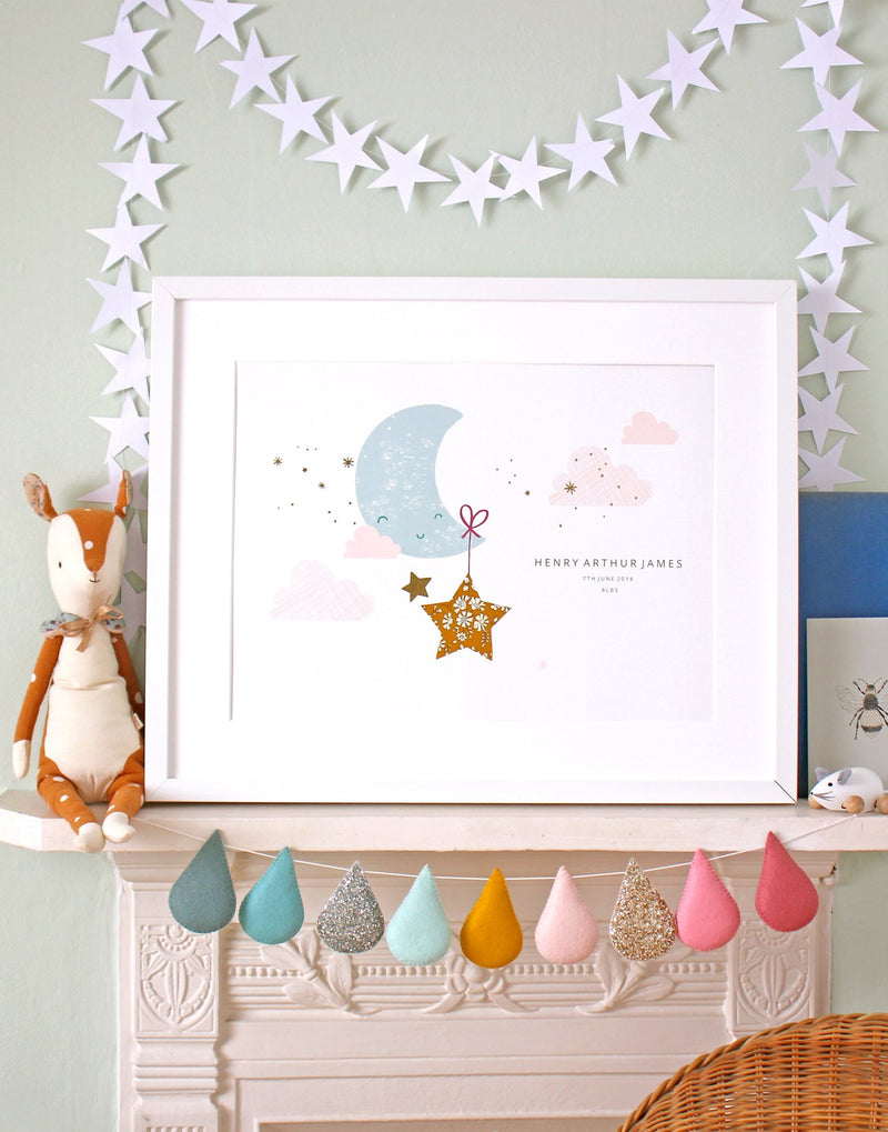 Child's bedroom shelf showing personalised moon and stars nursery art with Liberty print details by The Charming Press