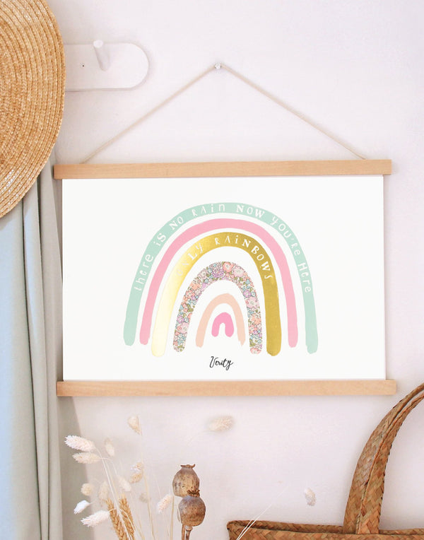 Pastel rainbow nursery print by The Charming Press hanging in children's bedroom.