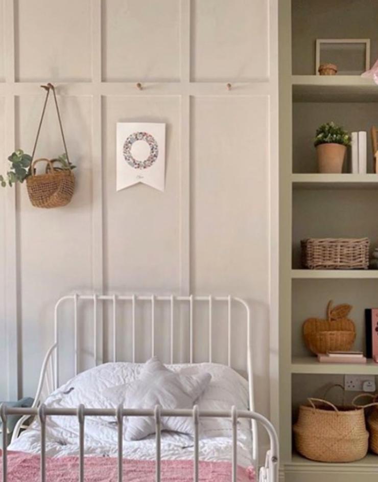 Child's bedroom with panelling accessories with hanging monogram flag.