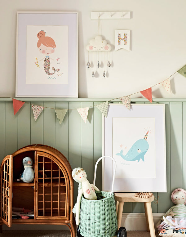 Under the sea inspired gallery wall in children's bedroom featuring mermaid and narwhal prints by The Charming Press