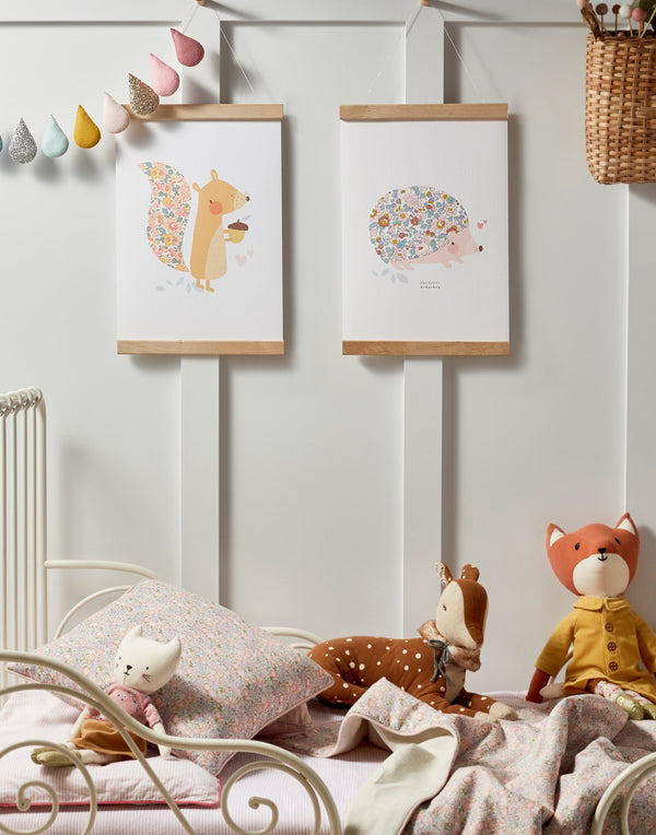 Gallery wall in children's bedroom featuring squirrel and hedgehog Liberty print art by The Charming Press