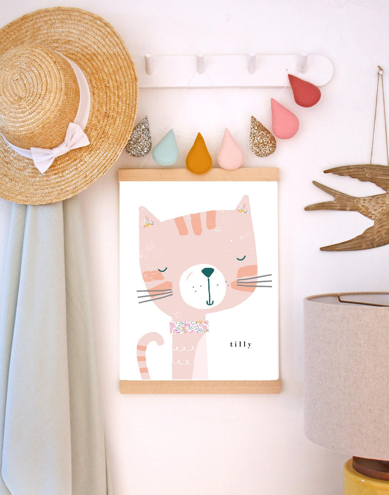 Peg shelf with hat, garland and cat print from The Charming Press on. 