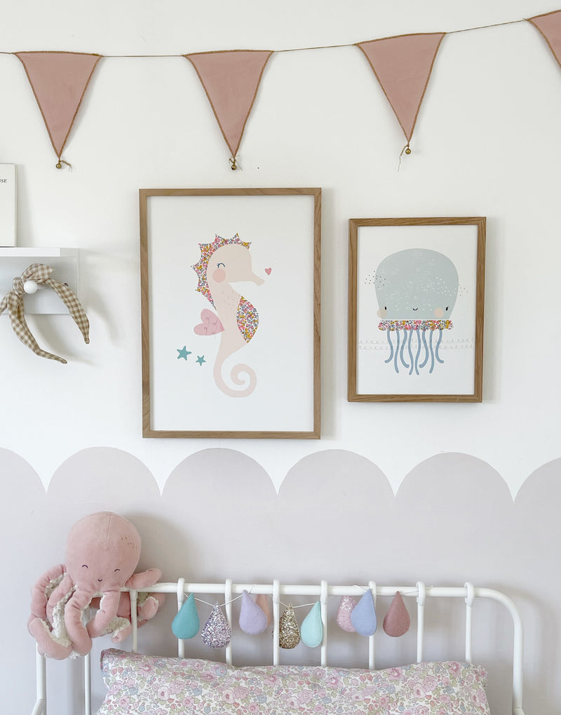 Girl's bedroom gallery wall showing under the sea prints, seahorse and octopus by The Charming Press