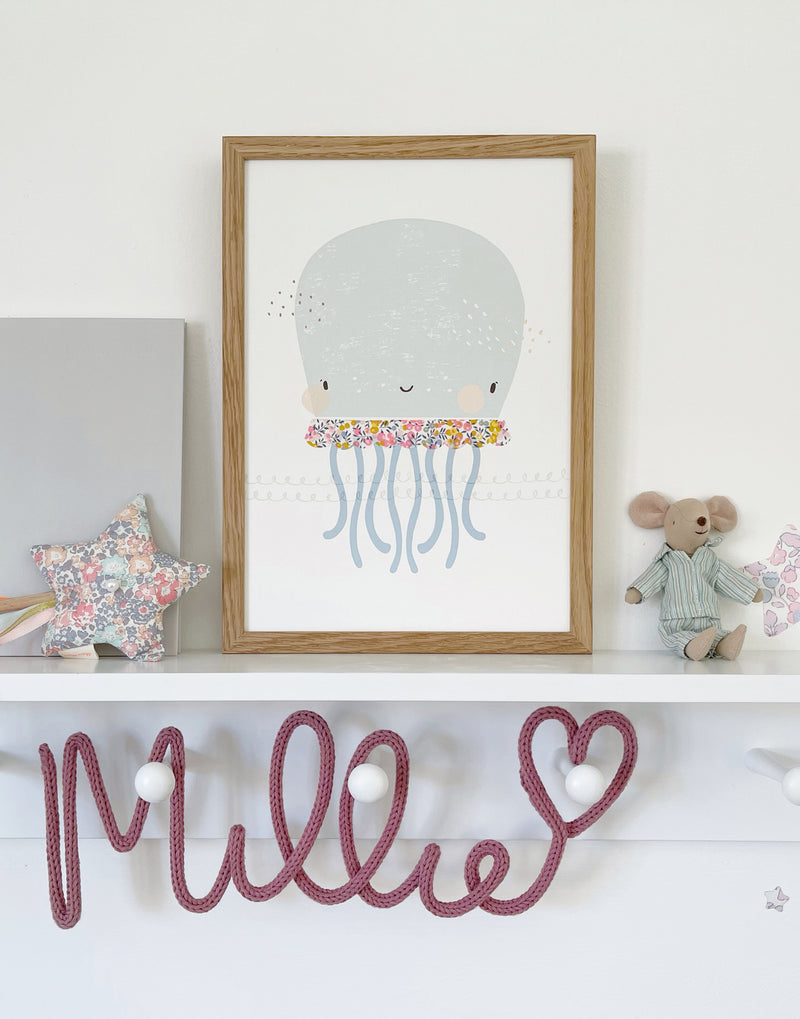 Liberty Octopus nursery print by The Charming Press shown on children's bedroom shelf