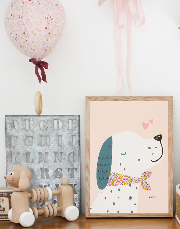 Little girl's bedroom decor showing Puppy dog nursery print by The Charming Press and other decor accessories.